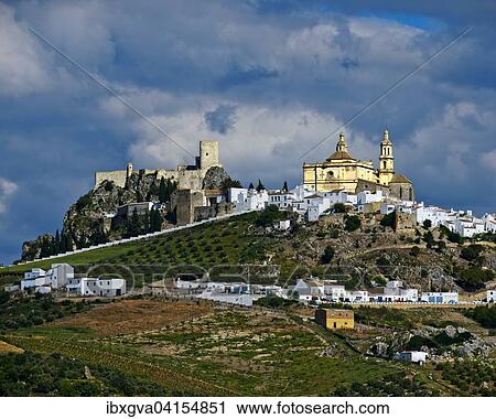 Stock Image - White town, pueblo blanco, with the Church of La Encarnacion and Moorish castle ruins, Olvera, Cadiz province, Andalucia, Spain, Europe. Fotosearch