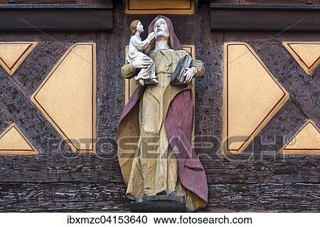 Wood-carved Mary holding the Infant Jesus at an old half-timbered house, Ettenheim, Baden-Wurttemberg, Germany, Europe View Large Photo Image Stock Image - Wood-carved Mary holding the Infant Jesus at an old half-timbered house, Ettenheim, Baden-Wurttemberg, Germany, Europe. Fotosearch