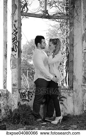 Young couple at a window in a ruined building covered in graffiti View Large Photo Image Stock Photograph - Young couple at a window in a ruined building covered in graffiti. Fotosearch