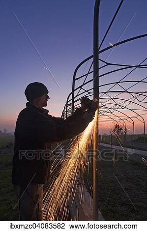 Young man grinding on a metal frame at dusk, sparks flying, Othenstorf, Mecklenburg-Western Pomerania, Germany, Europe View Large Photo Image Stock Image - Young man grinding on a metal frame at dusk, sparks flying, Othenstorf, Mecklenburg-Western Pomerania, Germany, Europe. Fotosearch