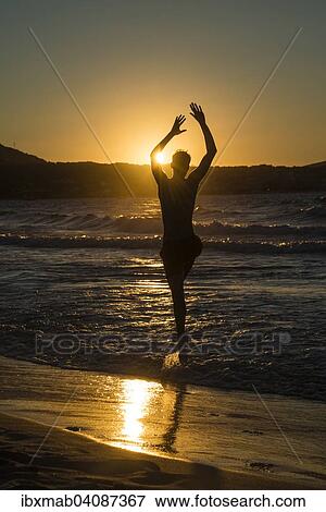 Young man, silhouette, jumping on the beach at sunset, sunset by the sea, Haute-Corse, Corsica, France, Europe View Large Photo Image Stock Photo - Young man, silhouette, jumping on the beach at sunset, sunset by the sea, Haute-Corse, Corsica, France, Europe. Fotosearch