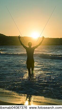 Young man, silhouette, on the beach at sunset, sunset by the sea, Haute-Corse, Corsica, France, Europe View Large Photo Image Stock Photograph - Young man, silhouette, on the beach at sunset, sunset by the sea, Haute-Corse, Corsica, France, Europe. Fotosearch