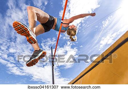 Stock Photo - Young woman, 18 years, high jump. Fotosearch