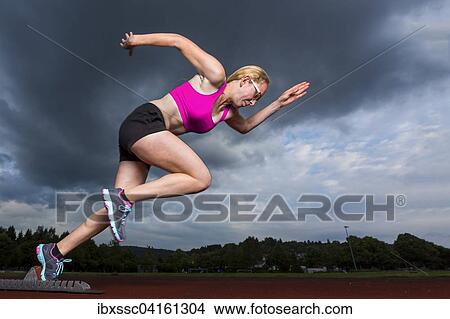 Young woman, 18 years, sprint start View Large Photo Image Picture - Young woman, 18 years, sprint start. Fotosearch