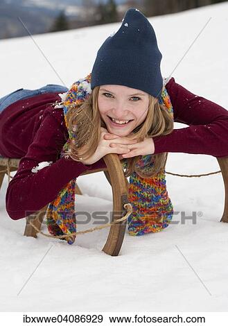 Young woman, 20 years, with a sled in the snow View Large Photo Image Stock Photo - Young woman, 20 years, with a sled in the snow. Fotosearch