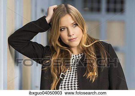 Young woman leaning with elbows on a wall, portrait View Large Photo Image Stock Image - Young woman leaning with elbows on a wall, portrait. Fotosearch