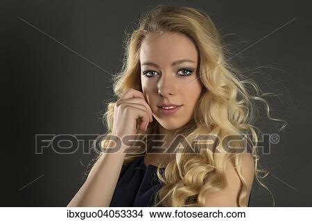 Picture - Young woman with long blond hair, portrait. Fotosearch