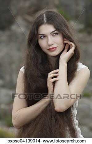 Young woman with long brown hair View Large Photo Image Picture - Young woman with long brown hair. Fotosearch