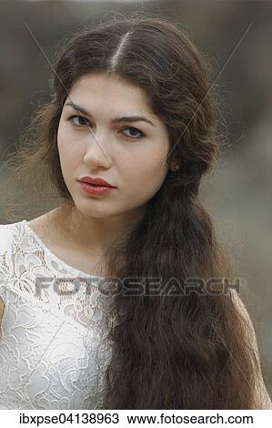 Stock Image - Young woman with long brown hair. Fotosearch