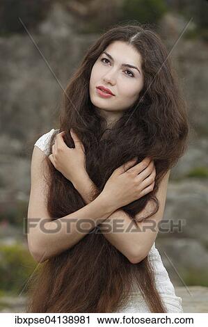 Stock Image - Young woman with long brown hair. Fotosearch