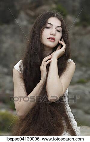 Stock Photograph - Young woman with long brown hair. Fotosearch