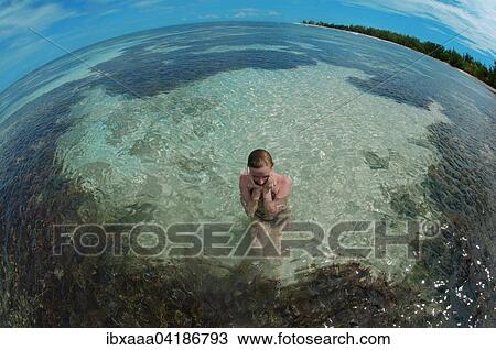 A young woman sitting in water, Denis Island, Seychelles, Africa View Large Photo Image Stock Image - A young woman sitting in water, Denis Island, Seychelles, Africa. Fotosearch