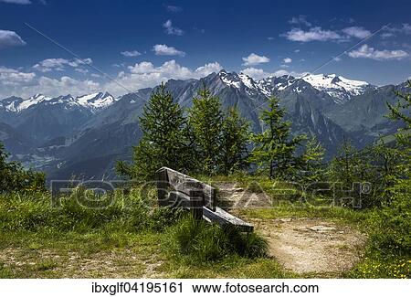Stock Image - Bench at Goldried overlooking the Grossvenediger, High Tauern National Park, East Tyrol, Tyrol, Austria, Europe. Fotosearch