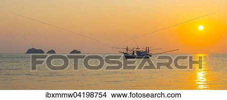 Picture - Boat in the sea at sunset in front of small islands, Koh Samui, Gulf of Thailand, Thailand, Asia. Fotosearch