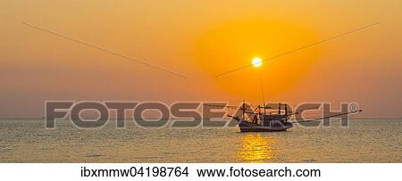 Boat in the sea at sunset in front of small islands, Koh Samui, Gulf of Thailand, Thailand, Asia View Large Photo Image Picture - Boat in the sea at sunset in front of small islands, Koh Samui, Gulf of Thailand, Thailand, Asia. Fotosearch