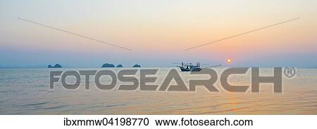 Boat in the sea at sunset in front of small islands, Koh Samui, Gulf of Thailand, Thailand, Asia View Large Photo Image Stock Image - Boat in the sea at sunset in front of small islands, Koh Samui, Gulf of Thailand, Thailand, Asia. Fotosearch