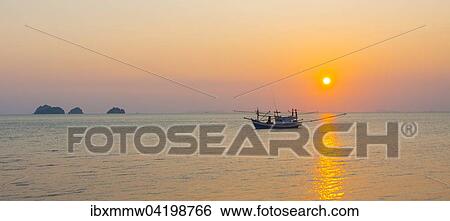 Stock Photograph - Boat in the sea at sunset in front of small islands, Koh Samui, Gulf of Thailand, Thailand, Asia. Fotosearch