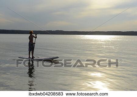 Boy, stand up paddle boarding, SUP, St. Heinrich, Starnberger See, Fuenfseenland, Upper Bavaria, Bavaria, Germany, Europe View Large Photo Image Stock Image - Boy, stand up paddle boarding, SUP, St. Heinrich, Starnberger See, Fuenfseenland, Upper Bavaria, Bavaria, Germany, Europe. Fotosearch