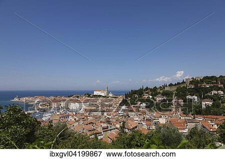 Stock Photo - Cityscape with lighthouse and Cathedral of St. George, Piran, Istria, Slovenian Littoral, Slovenia, Europe. Fotosearch