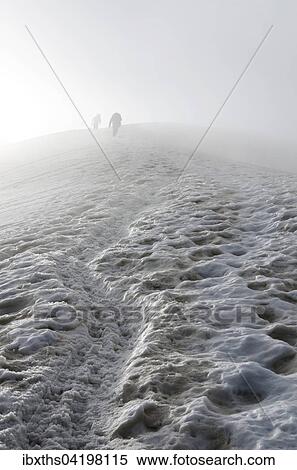 Climbers fading away in the fog, Triftgletscher glacier, West North West flank, Weissmies, Saas Valley, Valais Alps, Switzerland, Europe View Large Photo Image Stock Photography - Climbers fading away in the fog, Triftgletscher glacier, West North West flank, Weissmies, Saas Valley, Valais Alps, Switzerland, Europe. Fotosearch