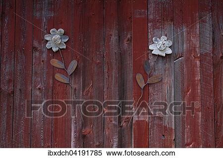 Stock Photography - Decorative flowers on red barn door, St. Paul d'Abbotsford, Eastern Townships, Quebec, Canada, North America. Fotosearch