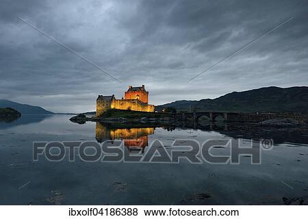 Eilean Donan Castle, ancestral seat of the Scottish clan of Macrae, reflection in the evening at Loch Duich, Dornie, Scottish Highlands, Scotland, United Kingdom, Europe View Large Photo Image Stock Photo - Eilean Donan Castle, ancestral seat of the Scottish clan of Macrae, reflection in the evening at Loch Duich, Dornie, Scottish Highlands, Scotland, United Kingdom, Europe. Fotosearch
