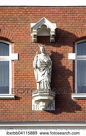Stock Photo - Figure of a saint on a house, Apellenplatz, Kevelaer, Lower Rhine, North Rhine-Westphalia, Germany,, Europe. Fotosearch