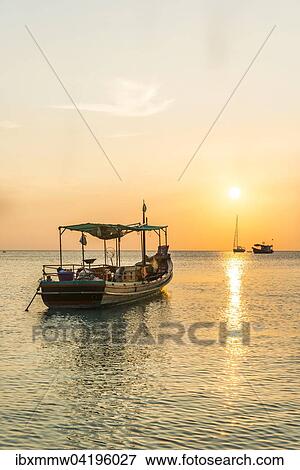 Stock Photo - Fishing boat in the sea at sunset, Koh Tao island, Gulf of Thailand, Thailand, Asia. Fotosearch
