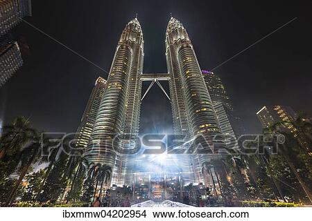 Fountain in front of the illuminated Petronas Tower at night, Kuala Lumpur, Malaysia, Asia View Large Photo Image Picture - Fountain in front of the illuminated Petronas Tower at night, Kuala Lumpur, Malaysia, Asia. Fotosearch