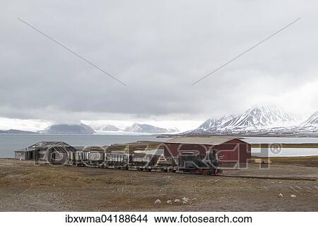 Picture - Historic mine train in front of Kongsfjorden, Ny-Alesund, Spitsbergen, Svalbard and Jan Mayen, Norway, Europe. Fotosearch