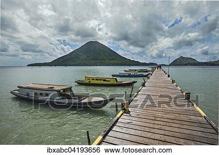Jetty of Lonthor, the volcano Gunung Api behind, Banda Islands, Moluccas, Indonesia, Asia View Large Photo Image Stock Photograph - Jetty of Lonthor, the volcano Gunung Api behind, Banda Islands, Moluccas, Indonesia, Asia. Fotosearch