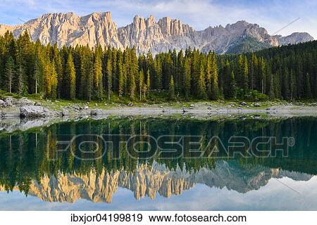 Karersee lake in front of Latemar, Lago di Carezza, Carezza, Dolomites, Trentino Province, Province of South Tyrol, Italy, Europe View Large Photo Image Stock Photo - Karersee lake in front of Latemar, Lago di Carezza, Carezza, Dolomites, Trentino Province, Province of South Tyrol, Italy, Europe. Fotosearch