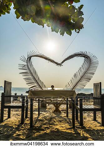 Laid table with a heart of palm fronds, sunset, Koh Samui, Gulf of Thailand, Thailand, Asia View Large Photo Image Picture - Laid table with a heart of palm fronds, sunset, Koh Samui, Gulf of Thailand, Thailand, Asia. Fotosearch