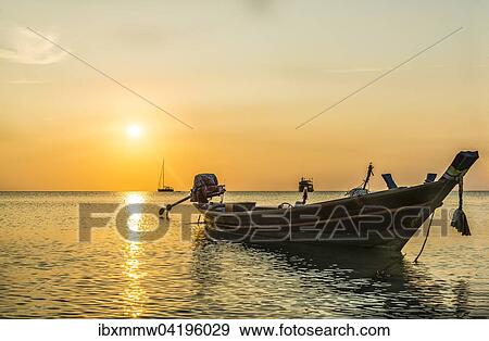 Longtail boat in the sea at sunset, Koh Tao island, Gulf of Thailand, Thailand, Asia View Large Photo Image Stock Photo - Longtail boat in the sea at sunset, Koh Tao island, Gulf of Thailand, Thailand, Asia. Fotosearch