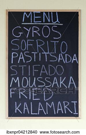 Stock Image - Menu on a blackboard, Greek dishes, gyros, Sofrito, Pastitsada, stifado, moussaka and fried calamari, Paleokastrista, island Corfu, Ionian Islands, Greece, Europe. Fotosearch
