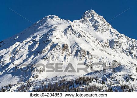 Stock Photo - Mountain range with snow, Maloja, Swiss Alps, Engadin, Canton of Graubunden, Switzerland, Europe. Fotosearch