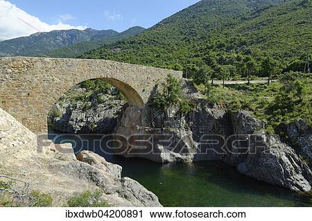 Stock Image - Ponte Vecchiu across the wild riverbed of the Fangu or Fango, Fango Valley, near Tuarelli, Galeria, Haute-Corse, Corsica, France, Europe. Fotosearch