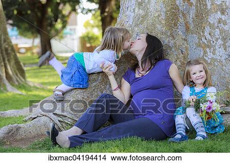 Picture - Pregnant woman in the park with her daughters, Tintenpalast, Windhoek, Namibia, Africa. Fotosearch