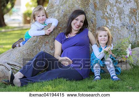 Stock Photography - Pregnant woman in the park with her daughters, Tintenpalast, Windhoek, Namibia, Africa. Fotosearch