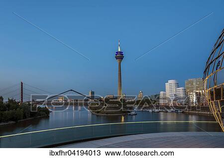 Rhine Tower and city harbor at dusk, Dusseldorf, North Rhine-Westphalia, Germany, Europe View Large Photo Image Stock Image - Rhine Tower and city harbor at dusk, Dusseldorf, North Rhine-Westphalia, Germany, Europe. Fotosearch
