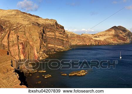 Rocky coast, Ponta de Sao Lourenco with a sailboat in the bay, Canical, Madeira Island, Portugal, Europe View Large Photo Image Stock Photo - Rocky coast, Ponta de Sao Lourenco with a sailboat in the bay, Canical, Madeira Island, Portugal, Europe. Fotosearch