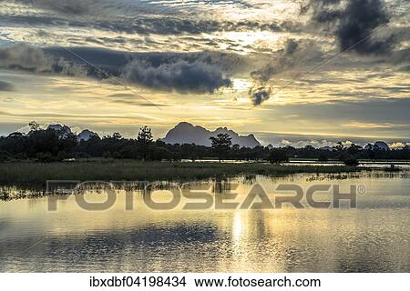 Sunset above tower karst mountains, artificial lake, landscape in the evening light, Hpa-an, Karen or Kayin State, Myanmar, Asia View Large Photo Image Picture - Sunset above tower karst mountains, artificial lake, landscape in the evening light, Hpa-an, Karen or Kayin State, Myanmar, Asia. Fotosearch