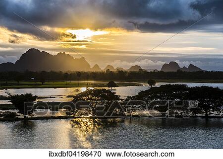 Sunset above tower karst mountains, artificial lake, landscape in the evening light, Hpa-an, Karen or Kayin State, Myanmar, Asia View Large Photo Image Stock Image - Sunset above tower karst mountains, artificial lake, landscape in the evening light, Hpa-an, Karen or Kayin State, Myanmar, Asia. Fotosearch