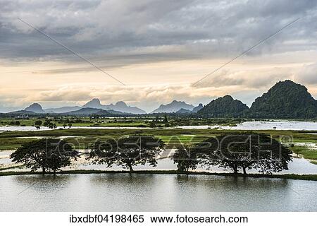 Stock Photography - Sunset above tower karst mountains, artificial lake, landscape in the evening light, Hpa-an, Karen or Kayin State, Myanmar, Asia. Fotosearch