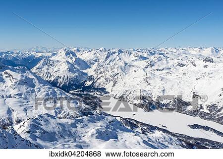 View of Lake Sils from Corvatsch, mountains in winter, Swiss Alps, Engadin, Canton of Graubunden, Switzerland, Europe View Large Photo Image Stock Photo - View of Lake Sils from Corvatsch, mountains in winter, Swiss Alps, Engadin, Canton of Graubunden, Switzerland, Europe. Fotosearch