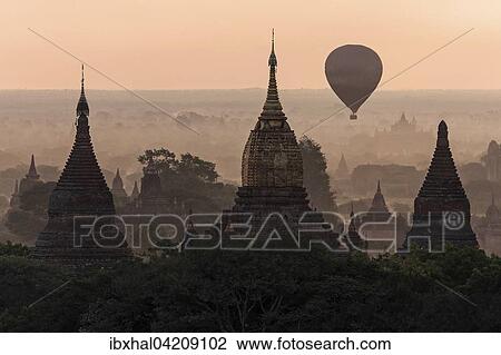 View of pagodas, temples, hot air balloon floating over pagodas field, sunrise, morning light, Bagan, Mandalay region, Myanmar, Asia View Large Photo Image Stock Image - View of pagodas, temples, hot air balloon floating over pagodas field, sunrise, morning light, Bagan, Mandalay region, Myanmar, Asia. Fotosearch