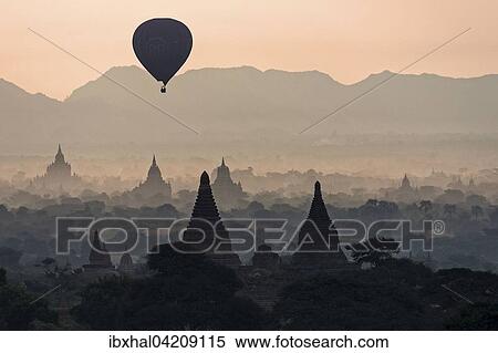 View of pagodas, temples, hot air balloon floating over pagodas field, sunrise, morning light, Bagan, Mandalay region, Myanmar, Asia View Large Photo Image Stock Photography - View of pagodas, temples, hot air balloon floating over pagodas field, sunrise, morning light, Bagan, Mandalay region, Myanmar, Asia. Fotosearch
