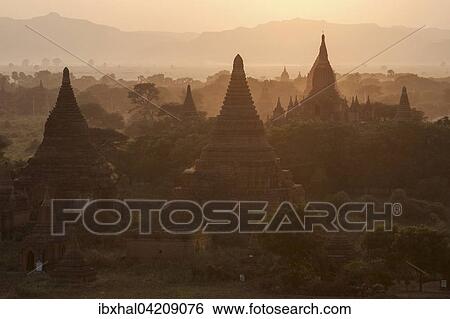 Stock Photograph - View of pagodas, temples, pagodas field, backlight, sunrise, morning light, Bagan, Mandalay region, Myanmar, Asia. Fotosearch