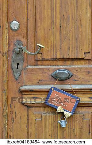 Wooden door with sign saying Bin im Garten, German for I'm in the garden, Baden-Wurttemberg, Deutschland View Large Photo Image Picture - Wooden door with sign saying Bin im Garten, German for I'm in the garden, Baden-Wurttemberg, Deutschland. Fotosearch