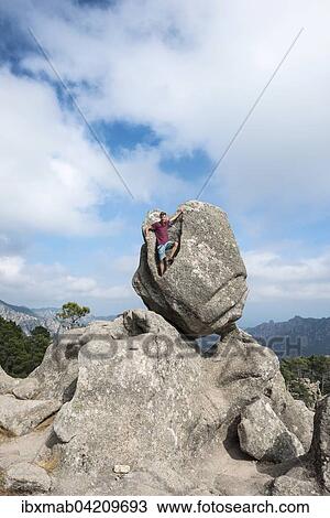 Young man standing in a rock formation, mountain landscape, L'Ospedale Alta Rocca, Corsica, France, Europe View Large Photo Image Stock Image - Young man standing in a rock formation, mountain landscape, L'Ospedale Alta Rocca, Corsica, France, Europe. Fotosearch